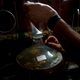 Esteves caps a jug of wine with a condom (AP Photo/Ramon Espinosa)